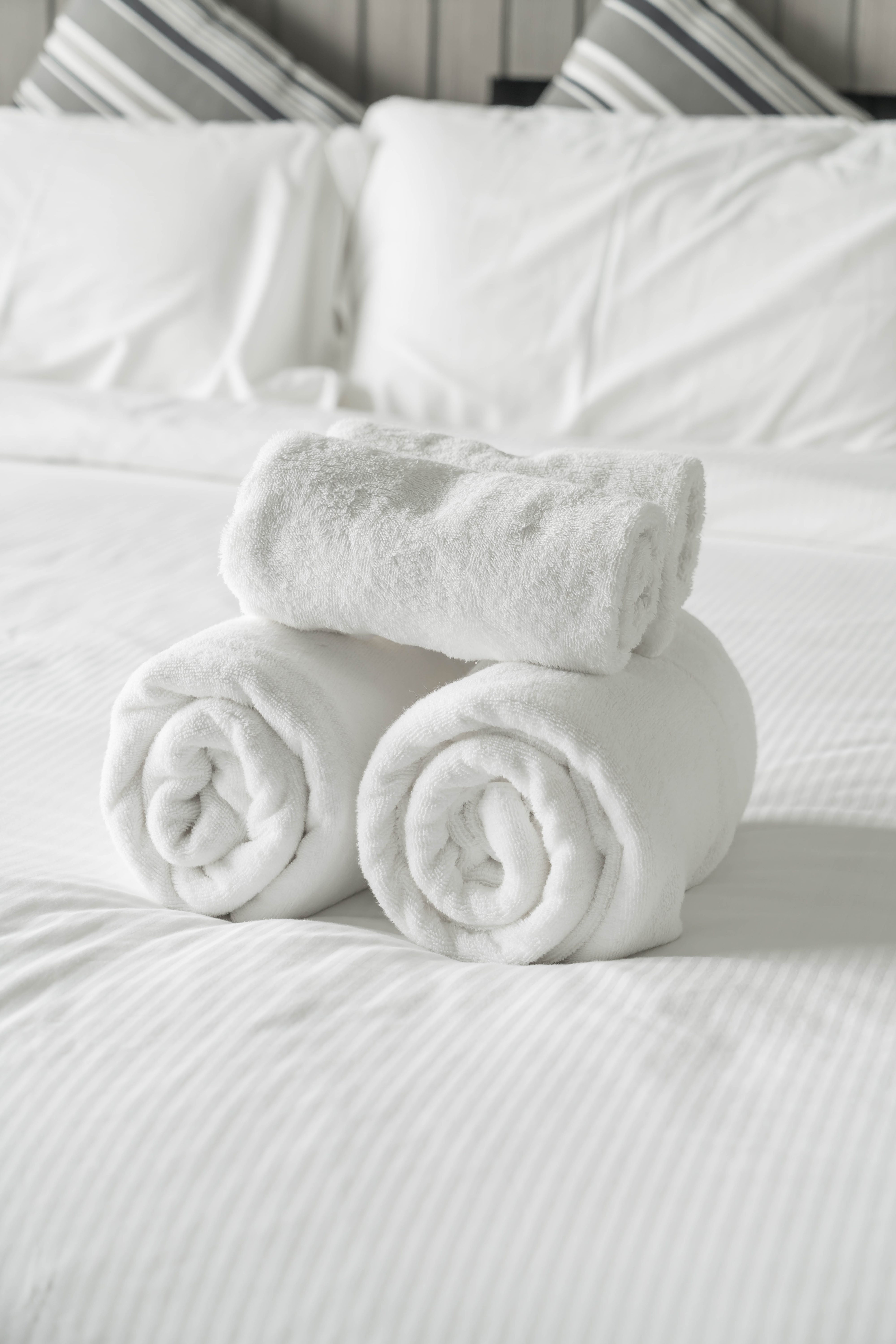 White towel on bed decoration in bedroom interior - Vintage light Filter